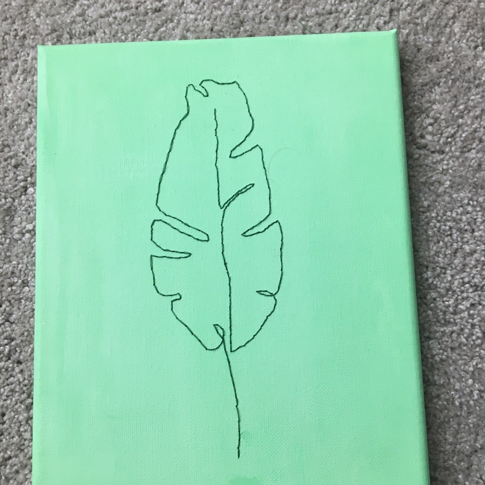 A green canvas with a green leaf